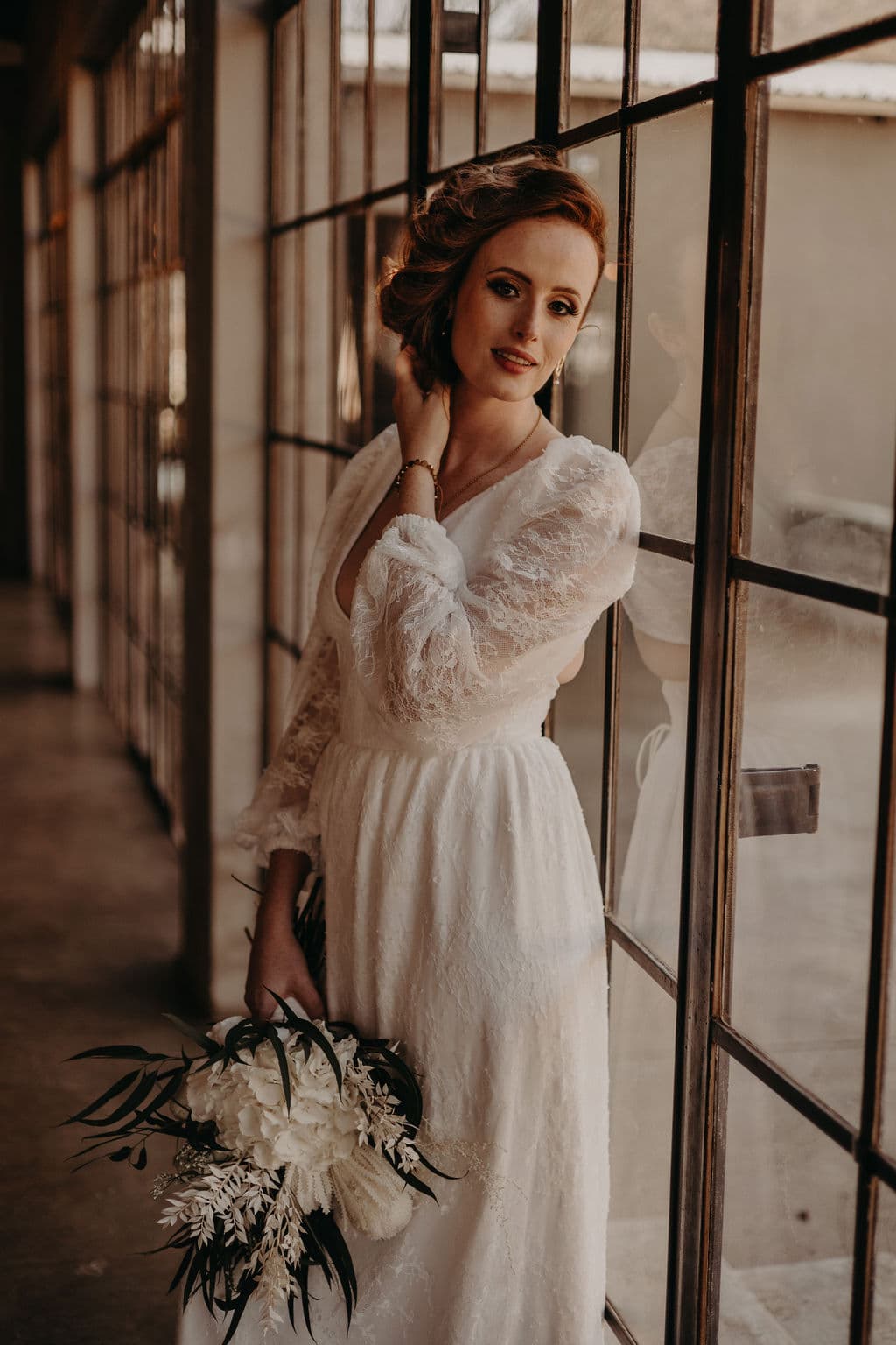 Bride against chapel window